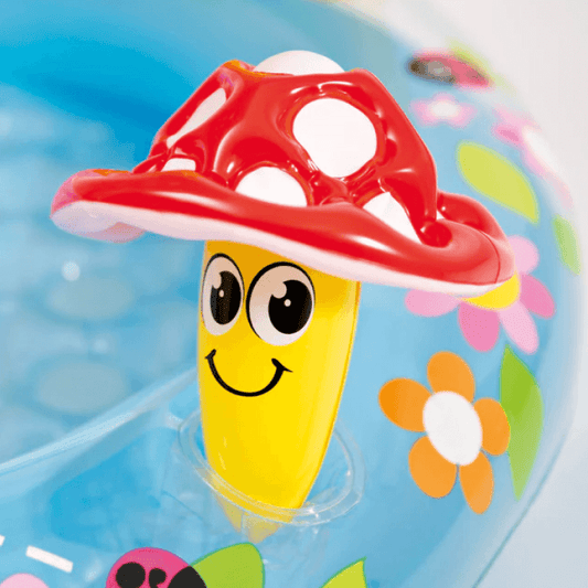 Close-up of a small yellow and red inflatable smiling mushroom toy integrated into the Intex baby pool.
