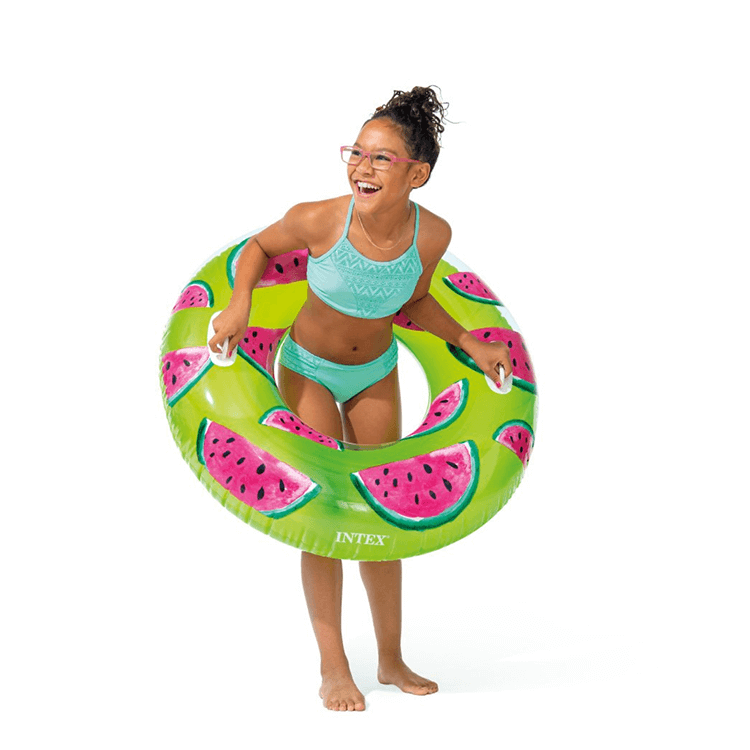 Young girl smiling and holding a 42-inch Intex Watermelon swim ring by its heavy-duty handles.