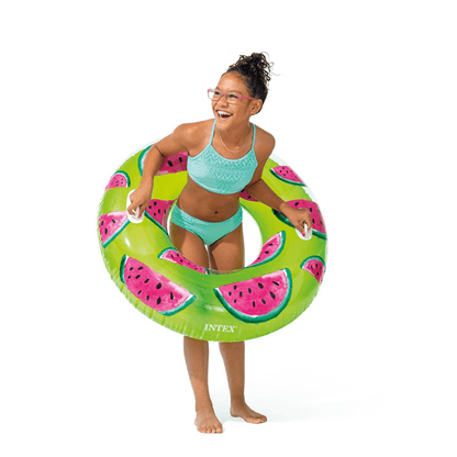 Young girl smiling and holding a 42-inch Intex Watermelon swim ring by its heavy-duty handles.