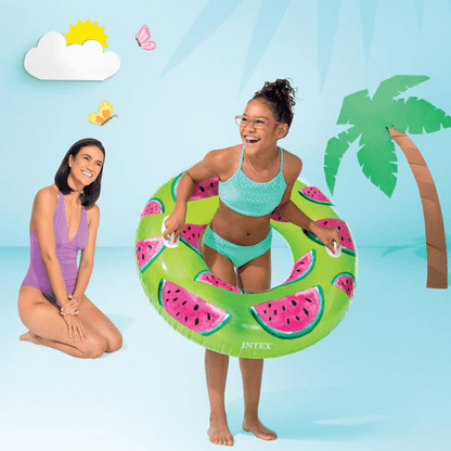 A girl playing with the Intex Watermelon pool tube while a woman watches nearby.