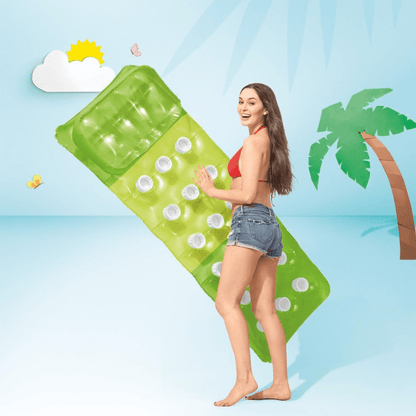A woman holding a bright green Intex 18-pocket pool lounge float against a light blue summer background.