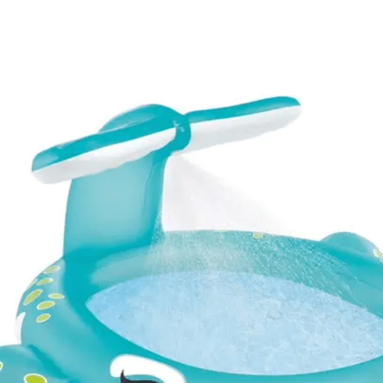 Close-up of the Intex Whale pool tail functioning as a water sprinkler, spraying a fan of water into the inflatable basin.